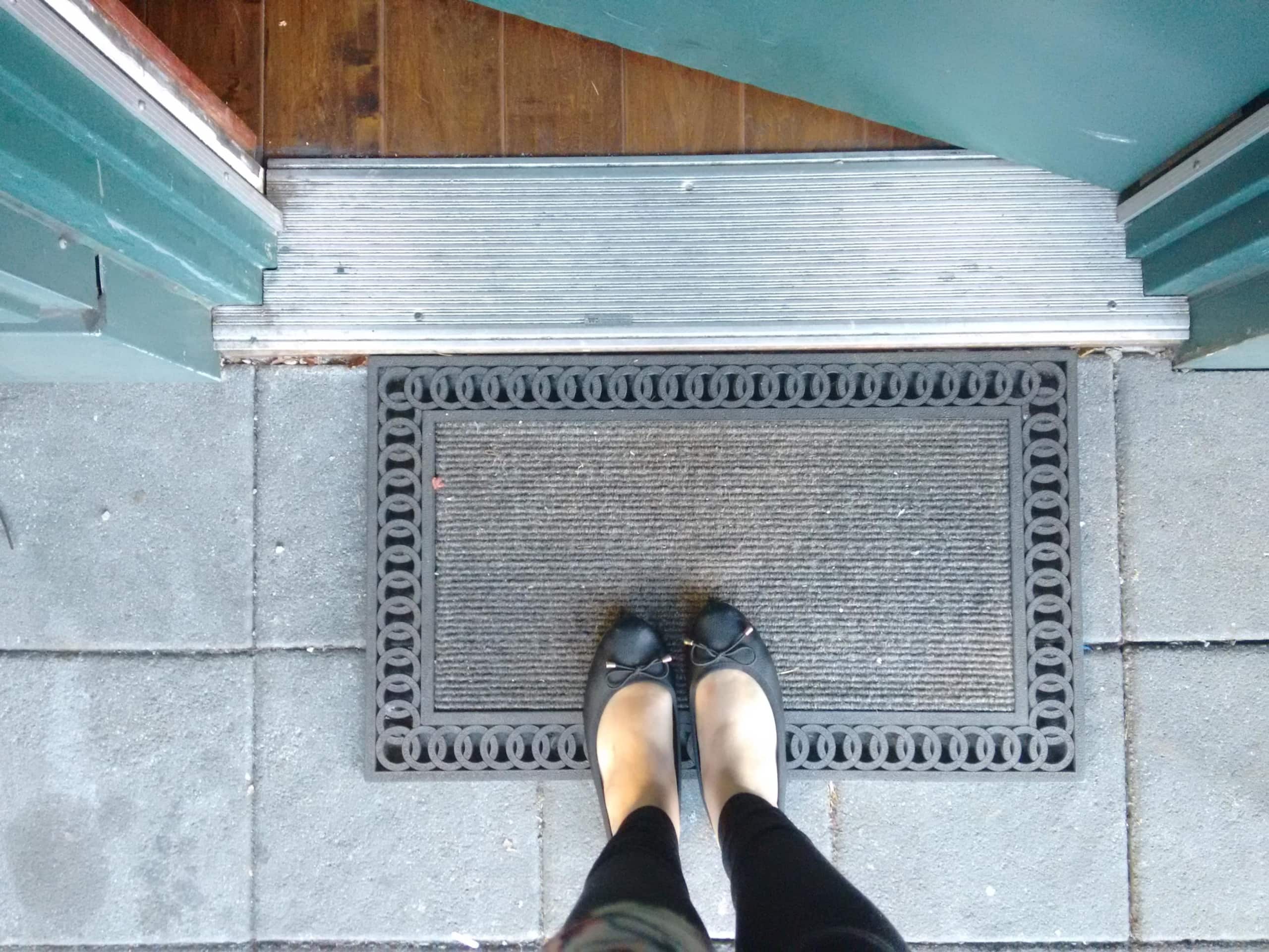 feet standing at a doormat